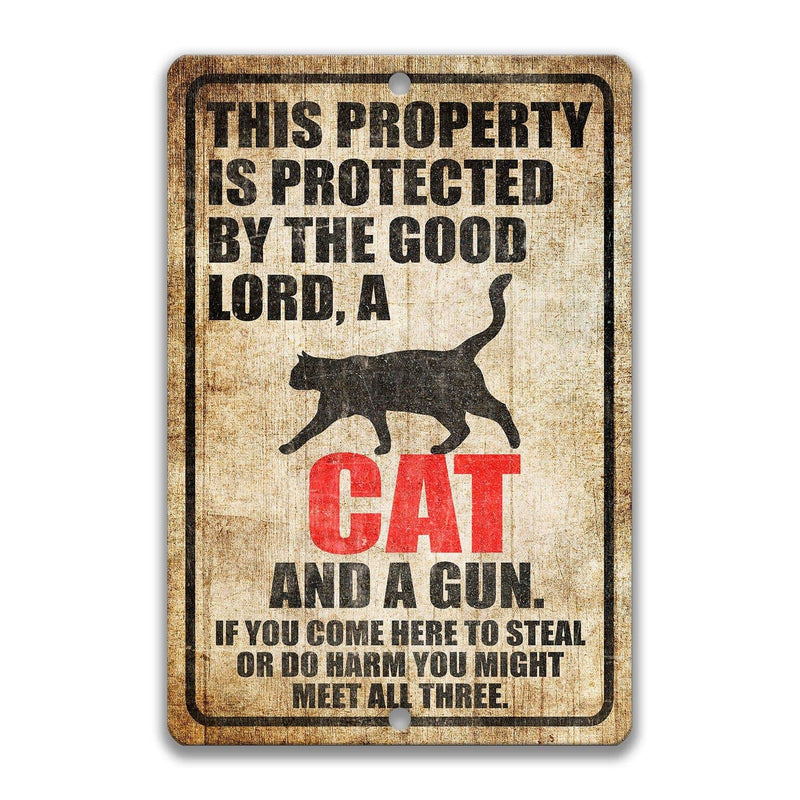 Cat Property Protected by the Good Lord, a Cat, and a Gun Cat Sign - Designs by Linda Nee