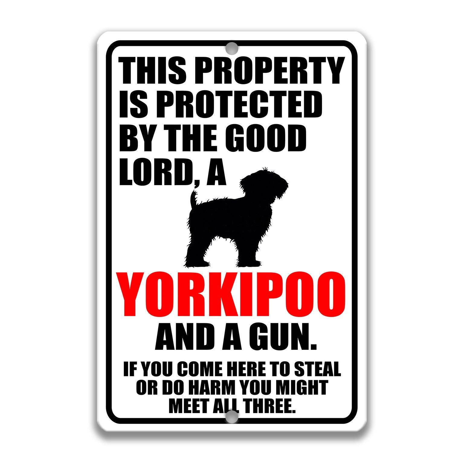 Property Protected by the Good Lord, a Yorkipoo, and a Gun Dog Sign