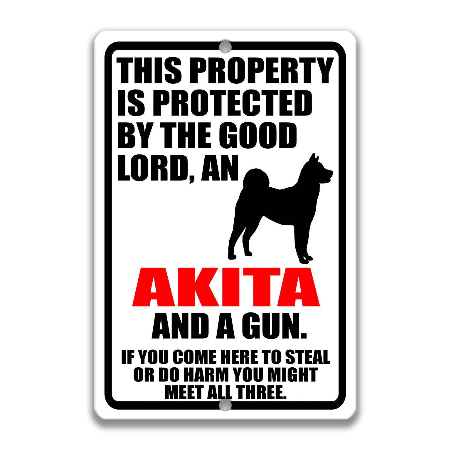 Property Protected by the Good Lord, an Akita, and a Gun Dog Sign